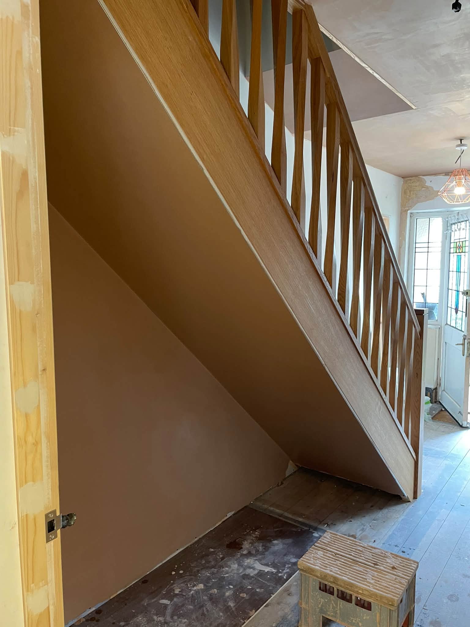 Under-stairs wall with a fresh plaster finish